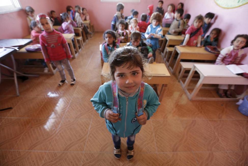 Five-year-old Shahd Mahmoud Abdel Hafez poses inside a classroom in the rebel-controlled area of Maarshureen villagein Idlib province, Syria March 12, 2016. March 15 marks the 5th anniversary of peaceful protests against Syria's President Bashar al-Assad, leading to the devastating civil conflict in the country. REUTERS/Khalil Ashawi