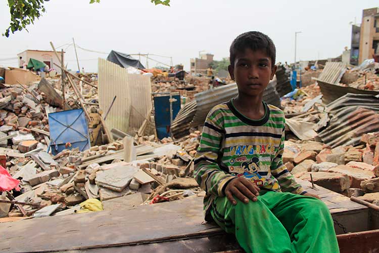 A young boy sits outside his demolished house. Children are most affected by this eviction as they now lack the place for recreational needs and many have not had food since their parents are busy in collecting/digging household belongings such as stove,Gas, Utensils. (Photographs taken on July6, 2017 )