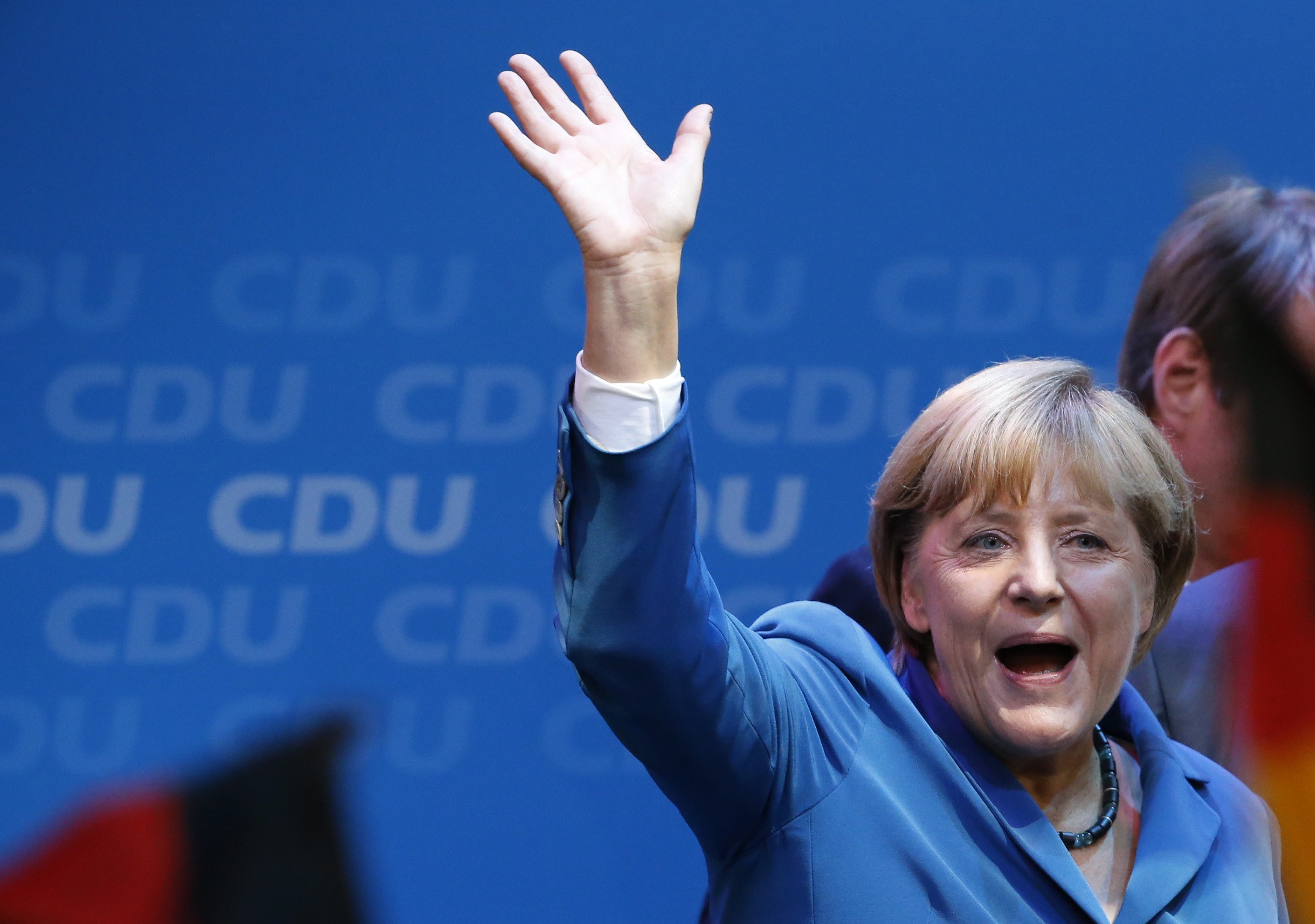 German Chancellor and leader of the Christian Democratic Union (CDU) Angela Merkel waves to supporters as she celebrates with party members after first exit polls in the German general election (Bundestagswahl) at the CDU party headquarters in Berlin September 22, 2013. Chancellor Angela Merkel won a landslide personal victory in a German election on Sunday, putting her within reach of the first absolute majority in parliament in half a century, a ringing endorsement of her steady leadership in the euro crisis.                REUTERS/Fabrizio Bensch (GERMANY  - Tags: POLITICS ELECTIONS)