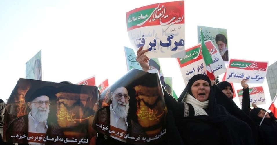 Iranian pro-government supporters in Mashhad hold posters of Supreme Leader Ayatollah Ali Khamenei during a rally after authorities declared the end of unrest on 4 January 2018 (AFP)