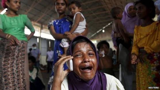 A Rohingya migrant who arrived in Indonesia by boat cries while speaking on a mobile phone with a relative in Malaysia, at a temporary shelter in Kuala Langsa in Indonesia's Aceh Province, 16 May 2015