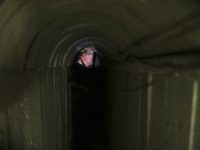 A Palestinian fighter from the Izz el-Deen al-Qassam Brigades, the armed wing of the Hamas movement, stands inside an underground tunnel in Gaza August 18, 2014. A rare tour that Hamas granted to a Reuters reporter, photographer and cameraman appeared to be an attempt to dispute Israel's claim that it had demolished all of the Islamist group's border infiltration tunnels in the Gaza war. Picture taken August 18, 2014. REUTERS/Mohammed Salem