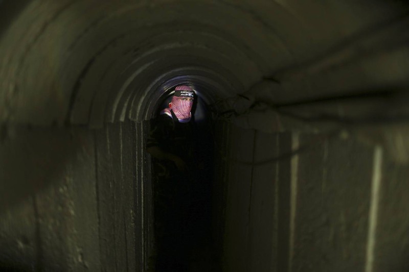 A Palestinian fighter from the Izz el-Deen al-Qassam Brigades, the armed wing of the Hamas movement, stands inside an underground tunnel in Gaza August 18, 2014. A rare tour that Hamas granted to a Reuters reporter, photographer and cameraman appeared to be an attempt to dispute Israel's claim that it had demolished all of the Islamist group's border infiltration tunnels in the Gaza war. Picture taken August 18, 2014. REUTERS/Mohammed Salem 