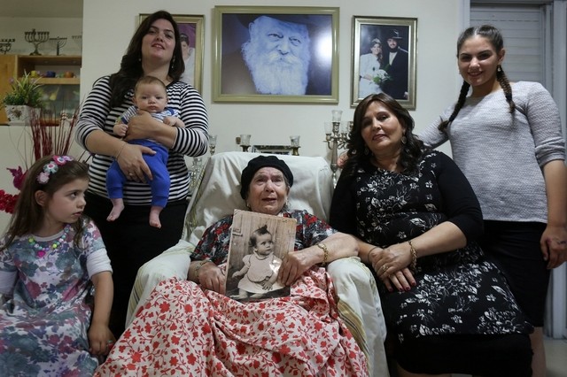 Frecha Amar, 84, an Israeli Jew of Moroccan descent, holds a picture of her baby, who she says was abducted in 1958, at her home in the village of Kfar Chabad, near Tel-Aviv (AFP PHOTO / MENAHEM KAHANA)