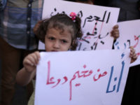 “I am from Deraa camp” reads a sign held by a girl during a demonstration outside UNRWA’s Gaza City headquarters in October 2013./ Ashraf Amra APA images