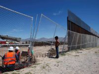 A boy looks at U.S. workers building a section of the U.S.-Mexico border wall at Sunland Park, U.S. opposite the Mexican border city of Ciudad Juarez, Mexico. REUTERS/Jose Luis Gonzalez