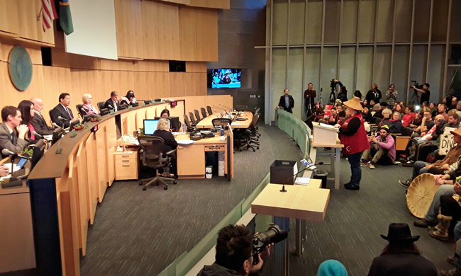Standing Rock Sioux tribal member Olivia One Feather testifies before the Seattle City Council in favor of divestment from Wells Fargo. Photo by J. Gabriel Ware.