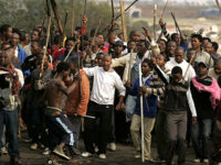 Protesters chant slogans during clashes believed to be linked to recent anti-foreigner violence in Reiger Park informal settlement, east of Johannesburg May 20, 2008. South Africa's police and the ruling ANC party intensified efforts on Tuesday to quell deadly violence against foreigners and a government minister said the unrest could damage the key tourism sector. At least 24 people have been killed in over a week of violent attacks on African migrant workers who are accused by many in South Africa's poor townships of stealing jobs and fuelling a wave of violent crime. REUTERS/Siphiwe Sibeko (SOUTH AFRICA)