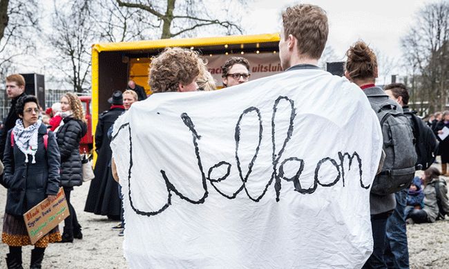 Two young men at a demonstration organized to protest against racism and Islamophobia in Amsterdam. Photo by Cloud-Mine-Amsterdam / iStock.