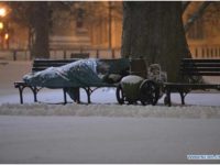 “A homeless sleeps amid a snow storm outside the White House in Washington D.C., capital of the United States…” [Photo: Xinhua/Zhang Jun]
