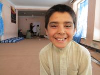 10-year-old Afghan Street Kid Mubasir smiles despite his difficulties