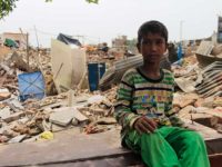 A young boy sits outside his demolished house. Children are most affected  by this eviction as they now lack the place for recreational needs and many have not had food since their parents are busy in collecting/digging household belongings such as stove,Gas, Utensils. (Photographs taken on July6, 2017 )
