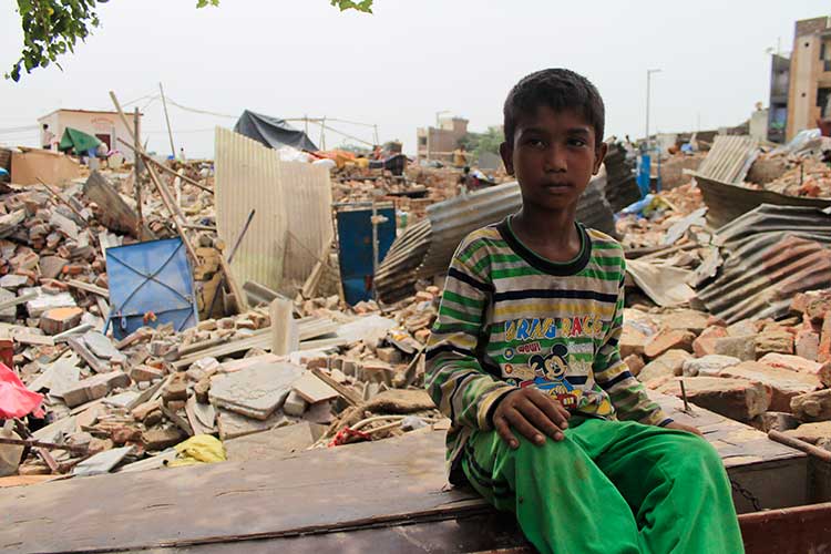 A young boy sits outside his demolished house. Children are most affected  by this eviction as they now lack the place for recreational needs and many have not had food since their parents are busy in collecting/digging household belongings such as stove,Gas, Utensils. (Photographs taken on July6, 2017 )