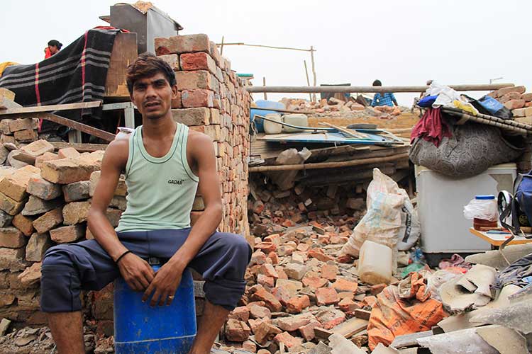 : Narendra (Name Changed), the resident sits outside his demolished house after the eviction that took place on July, 5, 2017