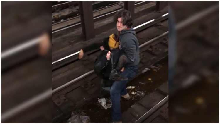 Utility worker jumps onto subway tracks, saves man just before train's arrival