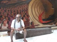 Djokopekik in front of his Papuan painting