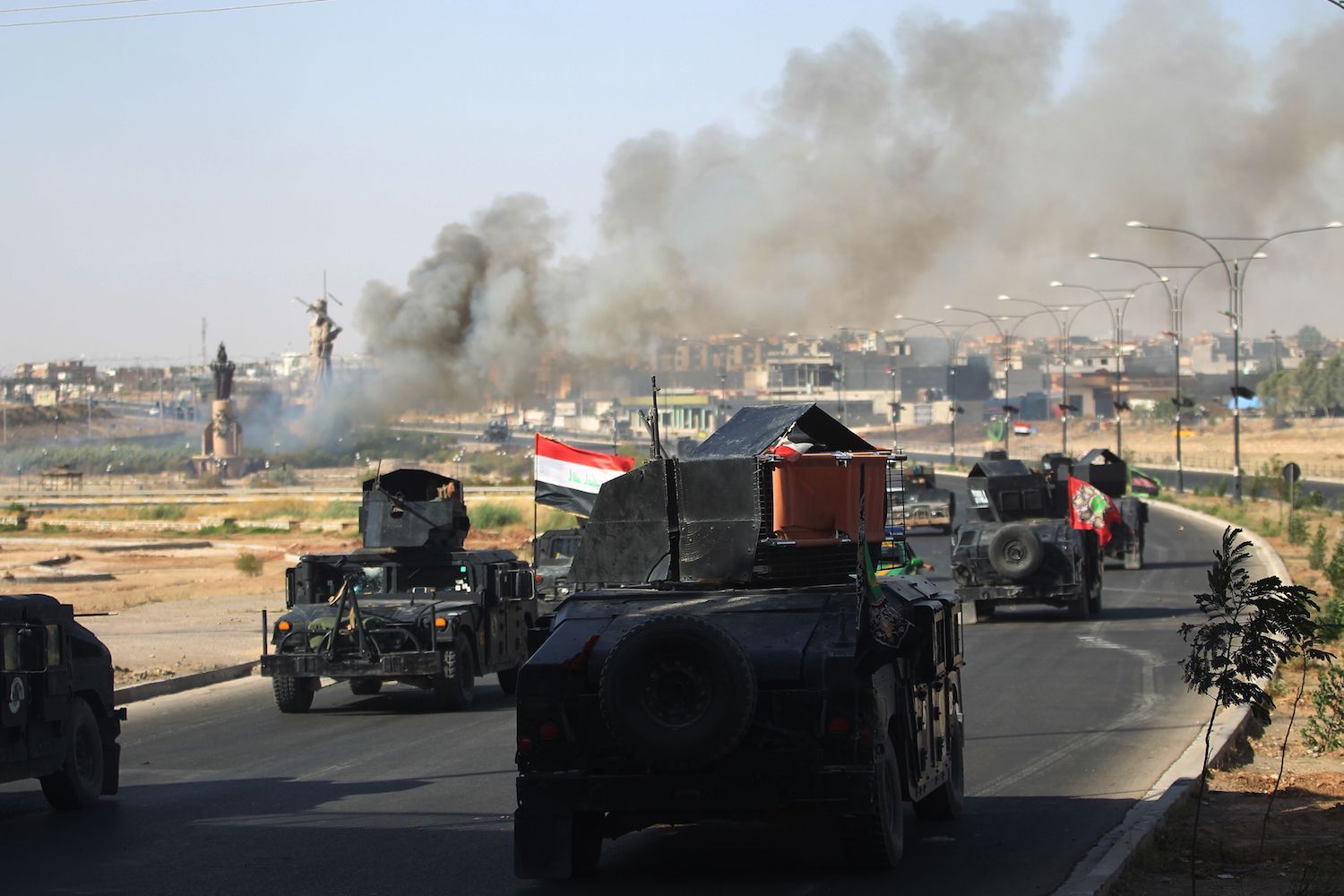 Smoke billows as Iraqi forces advance towards the centre of Kirkuk during an operation against Kurdish fighters on October 16, 2017.  Iraqi forces seized the Kirkuk governor's office, key military sites and an oil field as they swept across the disputed province following soaring tensions over an independence referendum. / AFP PHOTO / AHMAD AL-RUBAYE        (Photo credit should read AHMAD AL-RUBAYE/AFP/Getty Images)