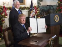 Donald Trump signs an executive order declaring Jerusalem the capital of Israel at the White House on 6 December. Chris KleponisCNP