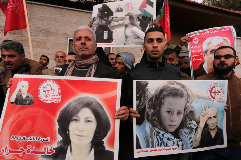 Protesters holding posters of Khalida Jarrar and Ahed Tamimi to show solidarity with Palestinian prisoners held in Israeli jails on 1 January in Gaza City. Ashraf Amra APA images