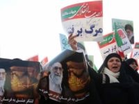 Iranian pro-government supporters in Mashhad hold posters of Supreme Leader Ayatollah Ali Khamenei during a rally after authorities declared the end of unrest on 4 January 2018 (AFP)