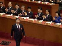 Chinese President Xi Jinping is applauded as he walks to the podium to deliver his speech at the opening ceremony of the 19th Party Congress held at the Great Hall of the People in Beijing, China, Wednesday, Oct. 18, 2017. Xi has told a key Communist Party congress that the nation's prospects are bright but the challenges are severe. (AP Photo/Ng Han Guan)
