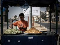 A Palestinian boy sells lupin beans on a street in Gaza City. Ashraf Amra APA images