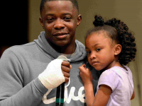 James Shaw Jr., who stopped the Waffle House shooter, becomes emotional as he holds his 4-year-old daughter, Brooklyn, at a vigil for the shooting victims.