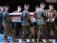 A Marine carry team moves a transfer case containing the remains of Lance Cpl. Nickolas A. Daniels at Dover Air Force Base, Del. Monday, Nov. 7, 2011. According to the Department of Defense, Daniels, 25, of Elmwood Park, Ill., died Nov. 5, 2011 while conducting combat operations in Helmand province, Afghanistan. (AP Photo/Steve Ruark)
