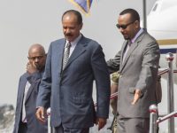 Eritrean President Isaias Afwerki, foreground left is welcomed by Ethiopia's Prime Minister Abiy Ahmed upon his arrival at Addis Ababa International Airport