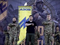 The Azov Battalion uses the Nazi Wolfsangel symbol as its logo. Its founder Andriy Biletsky (center) has moved to ban “race mixing” in the Ukranian parliament. (Azov/Twitter)