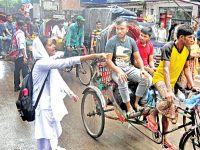A student directs rickshaw pullers to maintain lane discipline on Johnson Road in Old Town of Dhaka on Thursday. — New Age photo