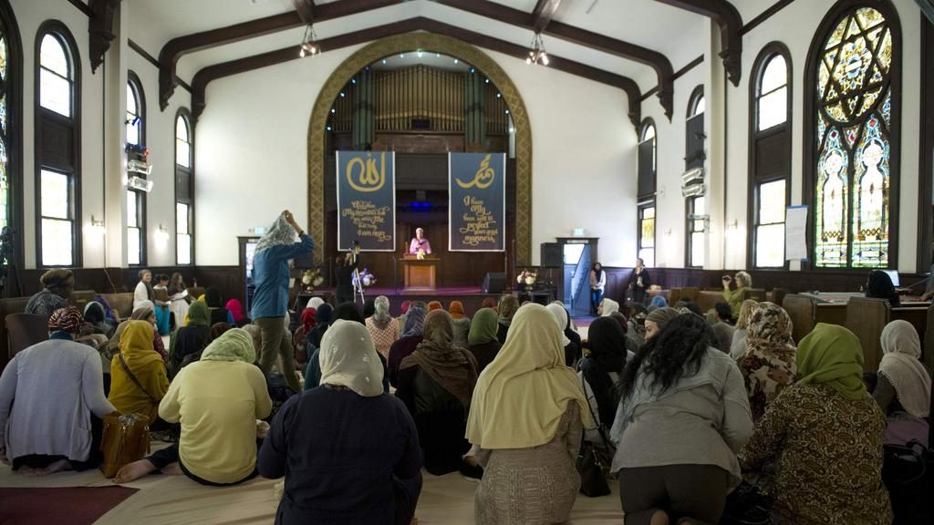 Muslim women pray in a mosque