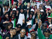 A crowd of Kuwaiti spectators erupt in cheers bearing a message of peace during the 50/20 Celebration parade in Kuwait Feb. 26. The 50/20 Celebration honors 50 years of Kuwaiti independence and the 20 years since Operations Desert Storm.