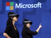 FILE- In this May 11, 2017, file photo, members of a design team at Cirque du Soleil demonstrate use of Microsoft's HoloLens device in helping to virtually design a set at the Microsoft Build 2017 developers conference in Seattle. Federal contract records show the U.S. Army has awarded Microsoft a $480 million contract to supply its HoloLens headsets to soldiers. The head-mounted displays use augmented reality, which means viewers can see virtual imagery superimposed over the real-world scenery in front of them. Microsoft says the technology will provide troops with better information to make decisions.(AP Photo/Elaine Thompson, File)