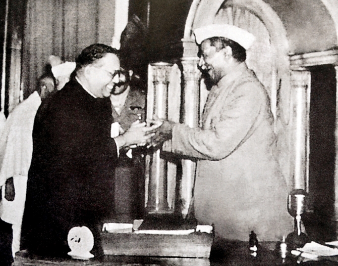Dr. Babasaheb Ambedkar chairman of the Drafting Committee presenting the final draft of the Indian Constitution to Dr. Rajendra Prasad on 25 November 1949