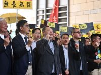 (L-R) Pro-democracy lawmaker Tanya Chan, baptist minister Chu Yiu-ming, sociology professor Chan Kin-man, law professor Benny Tai, former Democratic Party lawmaker Lee Wing-tat, Shiu Ka-chun and League of Social Democrats vice-chairman Raphael Wong chant before entering the West Kowloon Magistrates Court in Hong Kong on April 9, 2019, to find out if they face jail for their involvement in the 2014 Umbrella Movement protests. - They are among nine activists facing rarely used colonial-era public nuisance charges for their participation in the 2014 protests calling for free elections for the city's leader. (Photo by Anthony WALLACE / AFP)        (Photo credit should read ANTHONY WALLACE/AFP/Getty Images)
