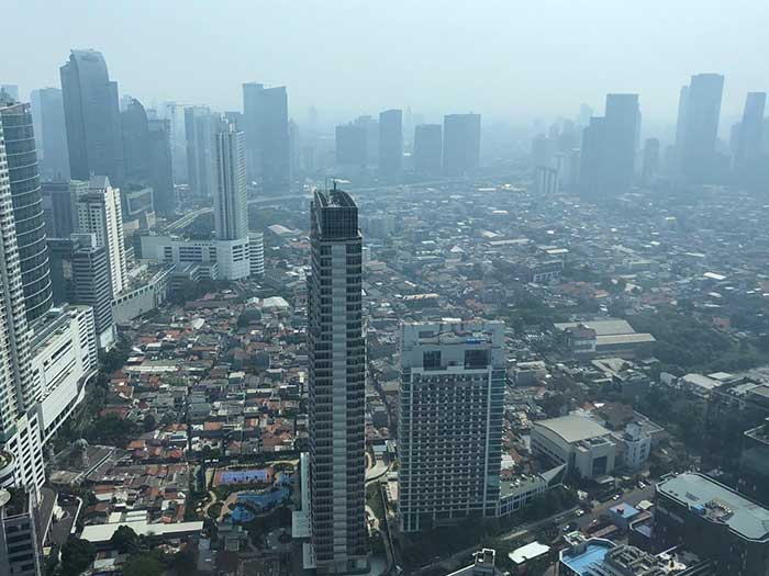 Jakarta smog and huge slums between skyscrapers