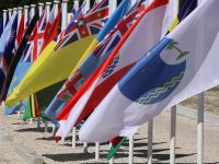 This picture taken on September 5, 2018 shows flags from the Pacific Islands countries being displayed in Yaren on the last day of the Pacific Islands Forum (PIF). - PIF members on September 5 signed a security agreement promoting cooperation on issues such as trans-national crime, illegal fishing and cyber-crime.The agreement, called the Boe Declaration, also recognised the need for joint action on "non-traditional" threats, primarily climate change. (Photo by Mike LEYRAL / AFP)        (Photo credit should read MIKE LEYRAL/AFP/Getty Images)