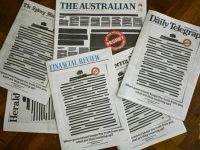 Australian media protest secrecy laws, redact their front pages