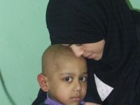 Adra and her 5-year-old son Atarid in hospital. Atarid suffered from cancer. He died on the 3rd day of the United States Shock and Awe bombing. Photo credit: Cathy Breen  March, 2003