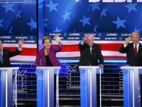 LAS VEGAS, NEVADA - FEBRUARY 19: Democratic presidential candidates (L-R) former New York City Mayor Mike Bloomberg as Sen. Elizabeth Warren (D-MA),  and Sen. Bernie Sanders (I-VT) react as raise their hands during the Democratic presidential primary debate at Paris Las Vegas on February 19, 2020 in Las Vegas, Nevada. Six candidates qualified for the third Democratic presidential primary debate of 2020, which comes just days before the Nevada caucuses on February 22. (Photo by Mario Tama/Getty Images)