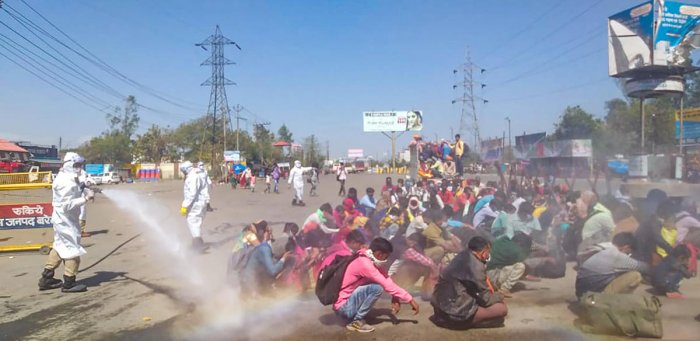 Disinfectant spray on Migrant workers corona