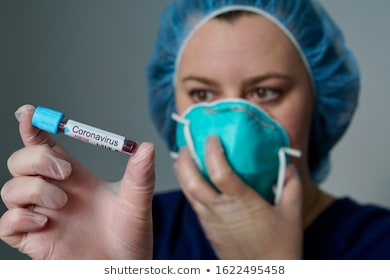 nurse wearing respirator mask holding 260nw 1622495458