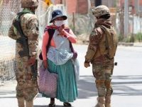 Soldiers question an indigenous woman on the way to buy food. Photo: TeleSUR
