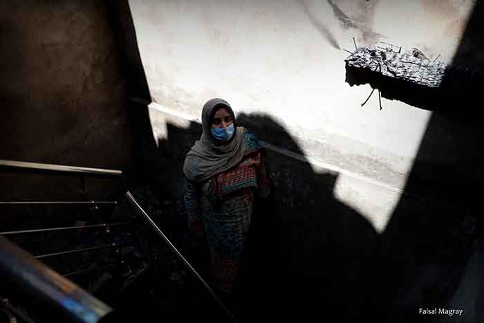 Nusrat 37 a young widow standing on the stairs of her damaged house in Srinagar Photo by Faisal Magray