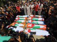 Palestinians mourn members of the Abu Hatab family during their funeral in Gaza City on 15 May.

 Ashraf Amra APA images