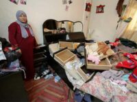 A Palestinian woman stands in a bedroom ransacked by Israeli soldiers during a night raid on her home in Balata refugee camp in the West Bank city of Nablus in January 2017. Ahmad Al-BazzActiveStills