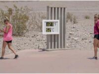 Visitors walk past the thermometer at the Furnace Creek Visitor Center in Death Valley, California, U.S. on June 17, 2021. (Kyle Grillot/Bloomberg via Getty Images)
