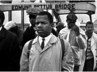 John Lewis from the Student Non Violent Coordinating Committee (SNCC) marching across the Edmund Pettus Bridge