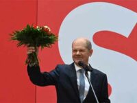 German Finance Minister, Vice-Chancellor and Social Democratic SPD Party’s candidate for chancellor Olaf Scholz holds up a bouquet of flowers at the party’s headquarters in Berlin. September 27, 2021